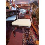 A set of six mahogany dining chairs having a carved bar to the back, upholstered in ivory fabric,