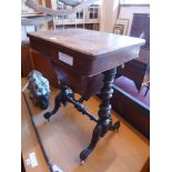 A Victorian walnut work table raised on turned supports, cabriole legs and castors.