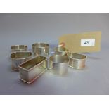 A collection of six hallmarked silver napkin rings including a pair,