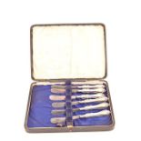Set of six Victorian cased silver handled dessert knives, with steel blades and scrolling shell work