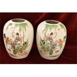 A pair of Chinese Qing Dynasty vases. The white underglazed body decorated with figures of