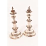 A pair of early 19th Century Old Sheffield Plate, extendable candlesticks standing on circular foot,