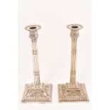 A very good quality pair of late 19th Century Georgian style candlesticks standing on square bases