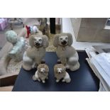 A set of four 19th Century Staffordshire dogs, Height 25cm