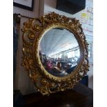 A 20th Century convex mirror, set in an