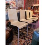 SOLD IN TIMED AUCTION A set of four Alessi cream leather dining chairs raised on tubular supports.