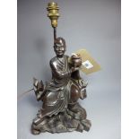 SOLD IN TIMED AUCTION A Chinese carved wood figure of a man holding a koro,