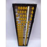 A 1930's Chinese abacus with yellow coun