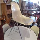 A set of four Charles Eames for Herman Miller fibreglass chairs on chrome legs