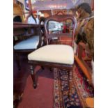 A set of six mahogany dining chairs having a carved bar to the back, upholstered in ivory fabric,