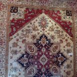 A Heriz style carpet with central medallion on a beige field contained by many borders.