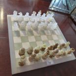 An onyx chess set with matching chess board.