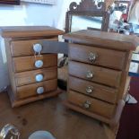 A pair of pitch pine miniature tabletop chests of four drawers.
