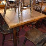 An oak draw leaf table raised on square section supports