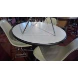 A Charles Eames circular table with white top and raised on chrome base,