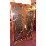 A Edwardian mahogany bookcase, having astragal glazed doors enclosing adjustable shelves,