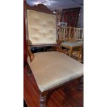 A Victorian mahogany button back salon chair with scallop shell cartouche raised on castors H 99cm
