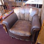 A pair of Art Deco brown leather armchairs with scallop shape back and raised on cabriole legs