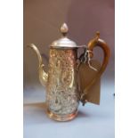 An 18th Century silver coffee pot embossed decorated with a lion and an eagle amongst foliage