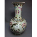 A Chinese famille rose porcelain vase decorated with pictorial reserves depicting birds amongst