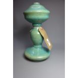 An 18th century/19th century Persian hand made pottery candle holder, having a turquoise glaze.