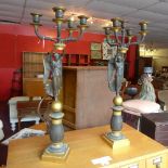 A pair of Empire bronze and ormulu five branch candelabras,