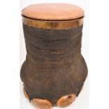 An antique taxidermy brass bound and leather upholstered Elephants Foot stool, H 51cm, W 44cm