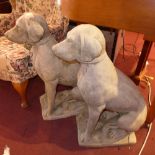 A pair of reconstituted stone dogs in se