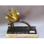 An Art Deco gilt bronze figural group of two birds on a branch, raised on marble base.