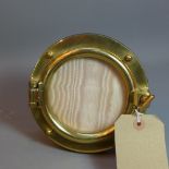 An Asprey brass porthole picture frame,