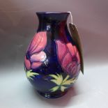 A Moorcroft baluster shape vase decorated with Panzi design on a blue ground.
