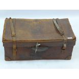 A brown leather suitcase, initialed to exterior with E.W.J, red fabric lining to interior, L.