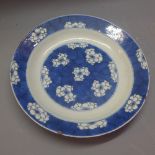 An early 19th Century Chinese Kanxi blue and white plate decorated with flowers with circle and