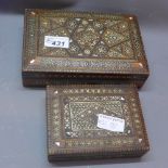 Three Edwardian mother of pearl buttons, cased, two North African inlaid wooden boxes, hinged lids,