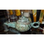 A Khorasan bronze oil lamp with faceted sides, long rectangular trough spout,