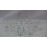 A collection of drinking glasses having star design with match decanters