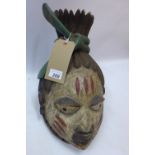 A 20th Century carved wooden Tribal Gelda head with hand painted face and traditional headdress H