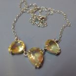 A silver and and three stone citrine set necklace