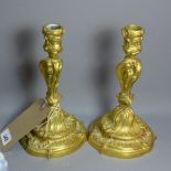 A pair of Rococo style gilt metal candlesticks.