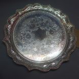 A silver card tray having beaded scalloped edge,