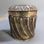 A silver lidded canister having turned decoration.