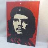 A large paining of Che Guevara on panelled wood,