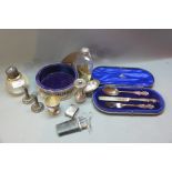A collection of silver items including an Etui, pepper grinder, egg cup, hip flask, coaster,
