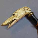 An ebonised walking cane with carved bone handle in the form of a grey hound head