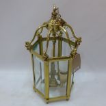A 20th Century heavy brass hexagonal lantern with bevelled glass panels.