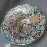 A large Czech green glass bowl, painted with a continuous design of riding noblemen in landscape,