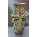 A Chinese famille rose vase decorated with figures in a courtyard scene,