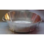 A large oval silver plated champagne bath on four feet