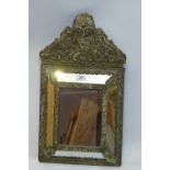 A 19th Century mirror with embossed brass mount,