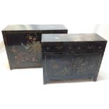 Two near matching Chinese black lacqured side cabinet decorated with flora and fauna